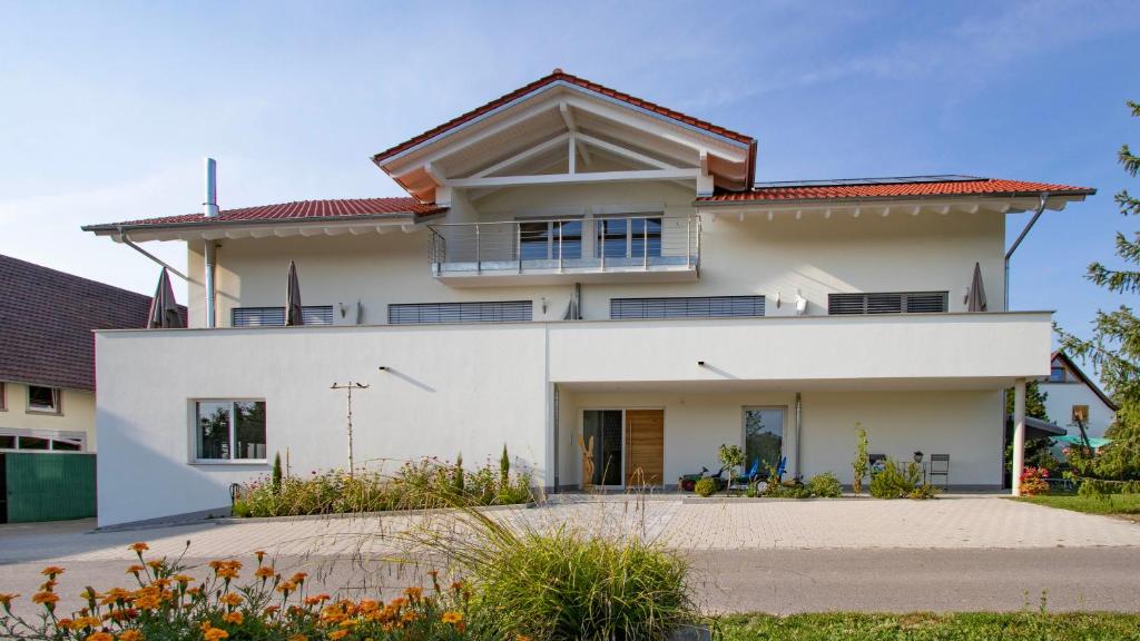 a white house with a red roof at Ferienhof Haas in Friedrichshafen