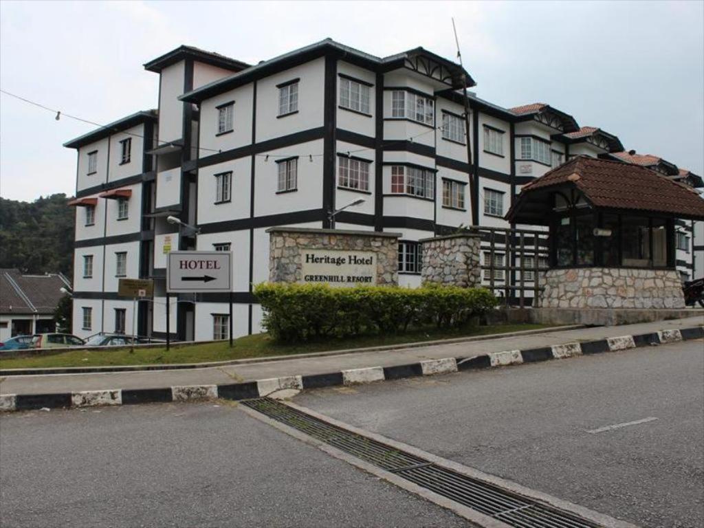 a large white building on the side of a street at Green Hill Resort Tanah Rata 3R2B WiFi in Tanah Rata