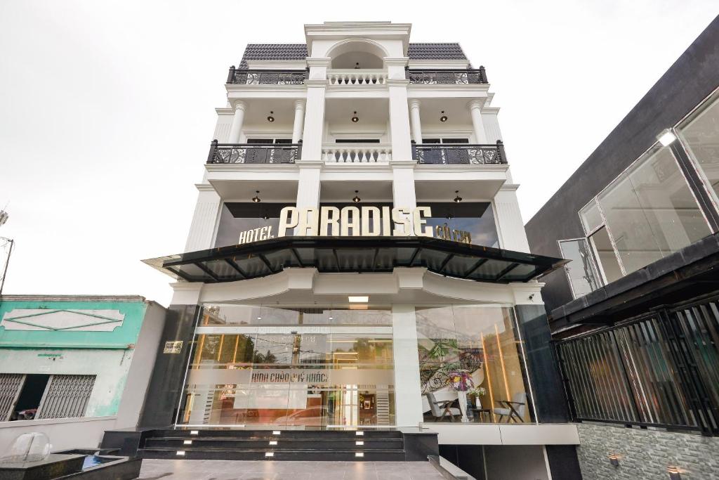 un edificio blanco alto con un letrero. en Paradise Cu Chi Hotel, en Củ Chi