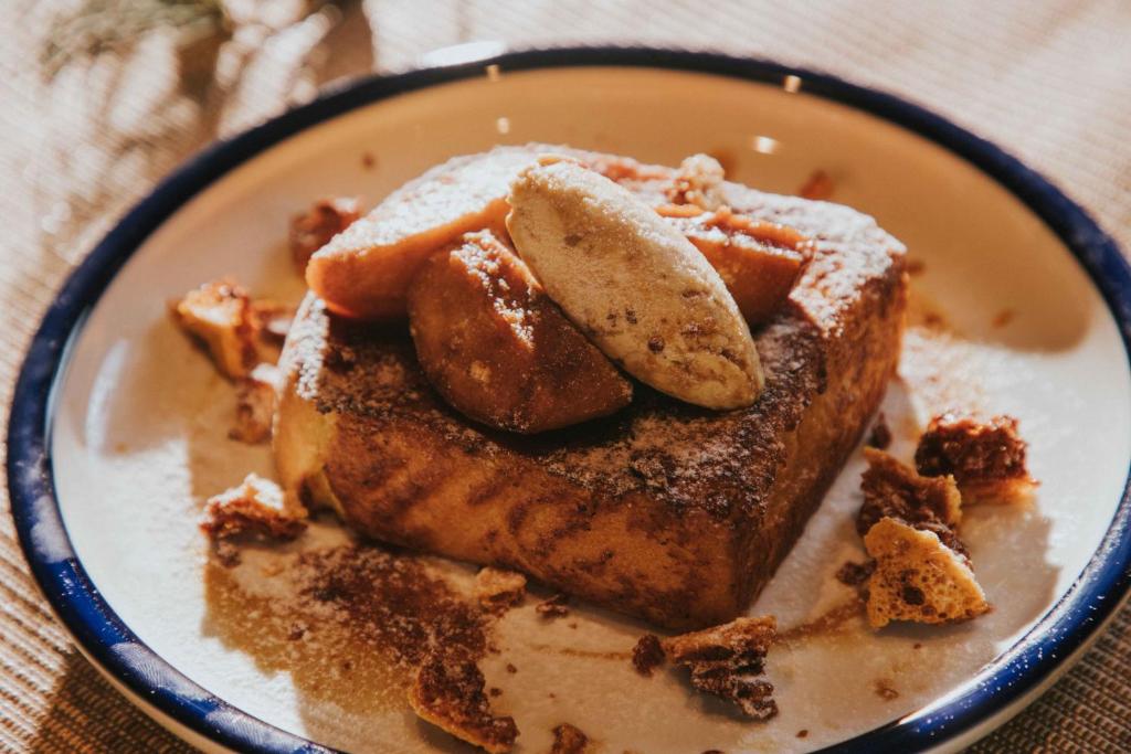 a plate of food with french toast and bananas at Kimpton Da An Taipei- an IHG Hotel in Taipei