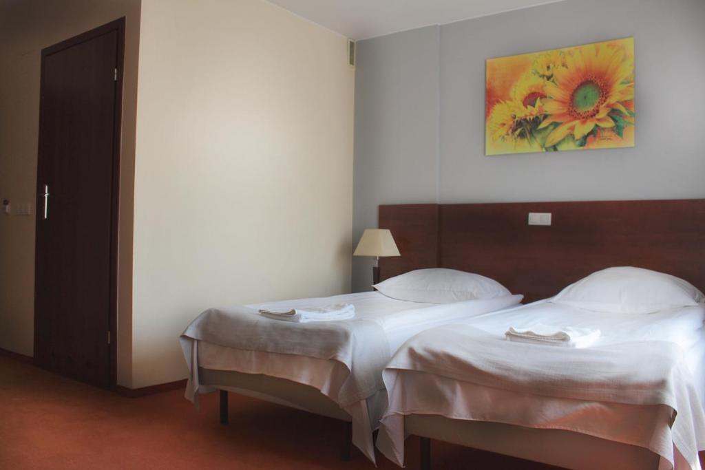 Łóżko lub łóżka w pokoju w obiekcie Hotel Gordon