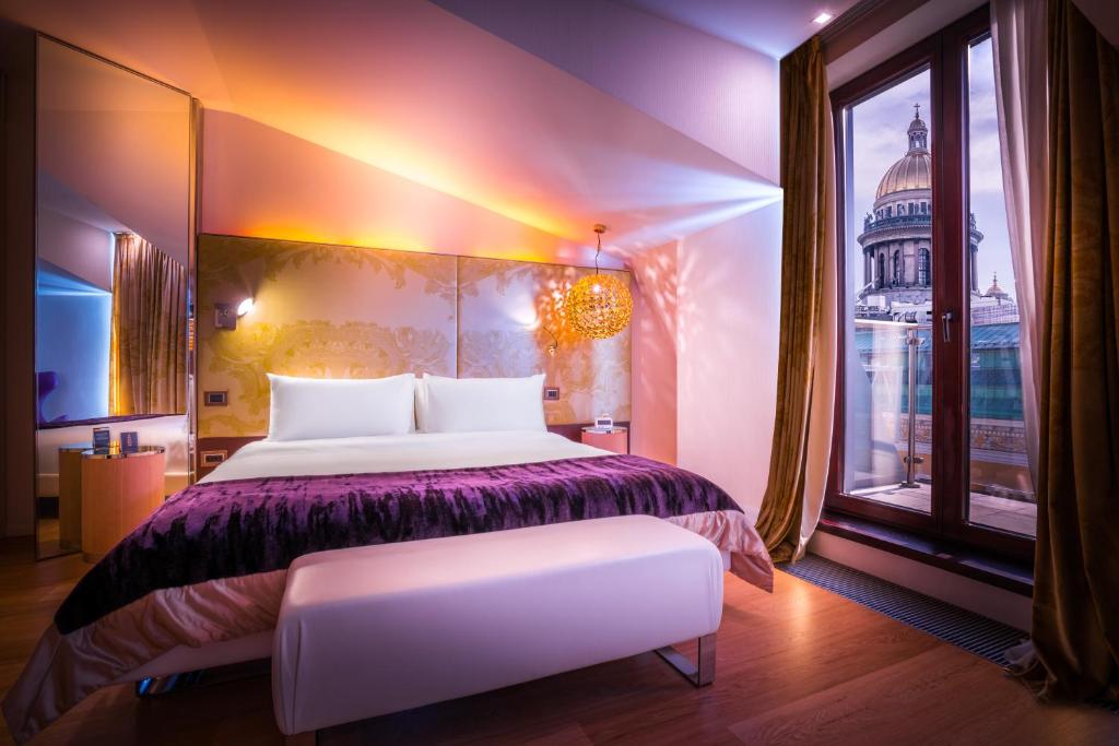 a bedroom with a large bed and a window at SO/ Saint Petersburg in Saint Petersburg