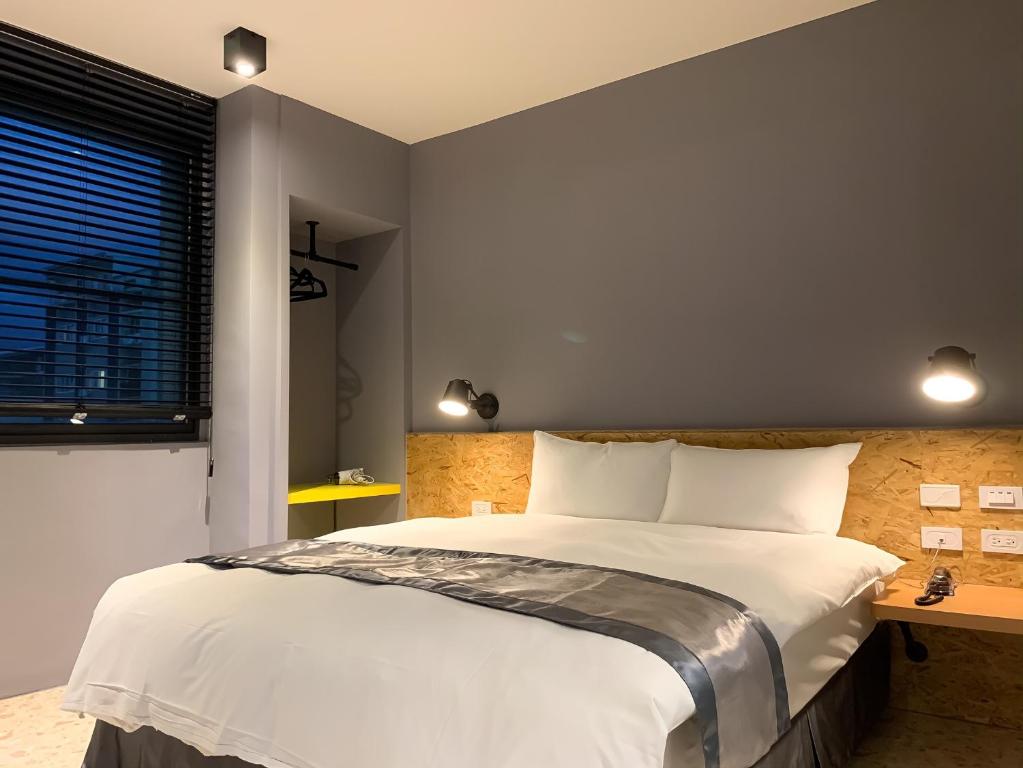 Postel nebo postele na pokoji v ubytování Raise Hotel Taichung