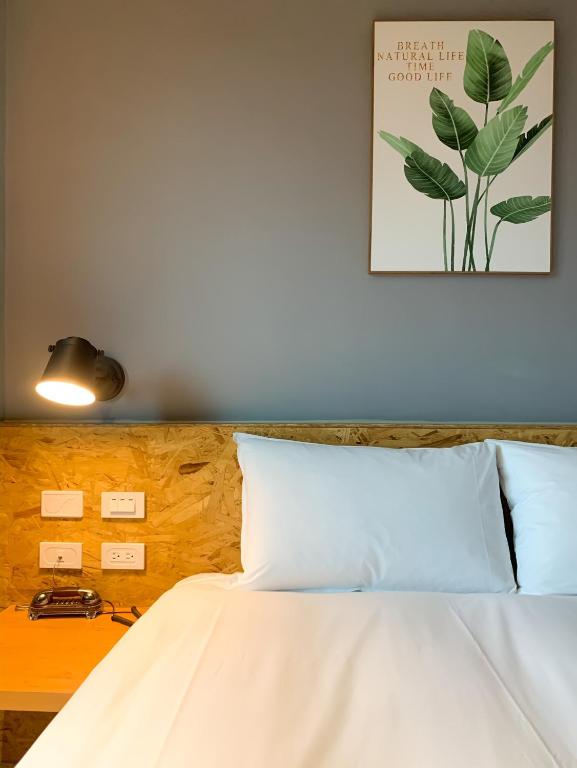 Postel nebo postele na pokoji v ubytování Raise Hotel Taichung