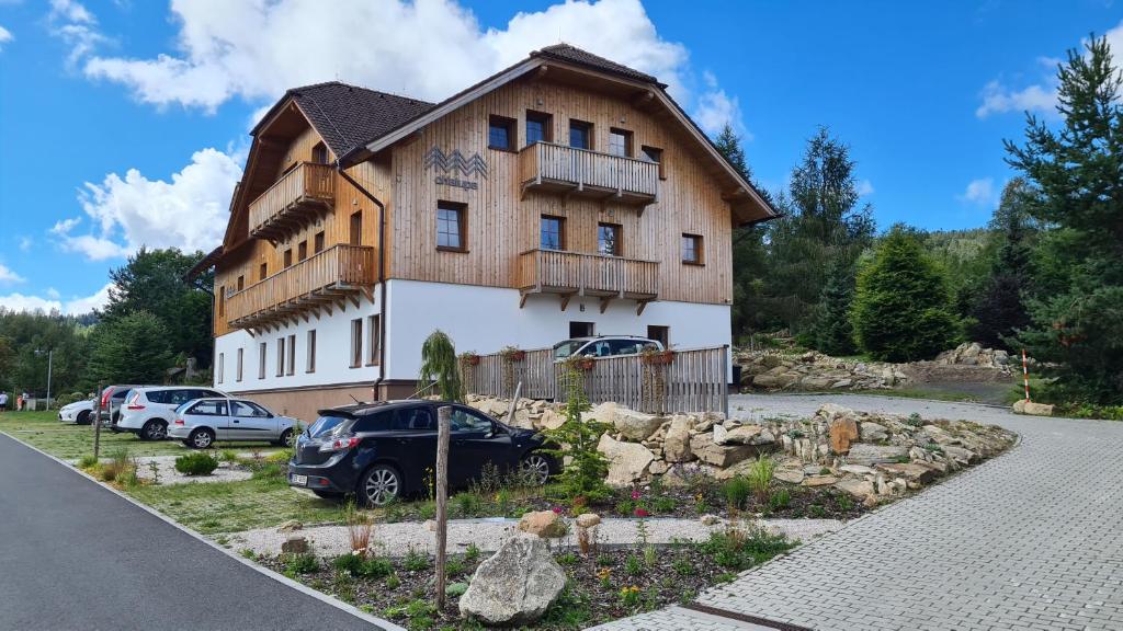 a house with a car parked in front of it at hotel Chalupa in Prášily