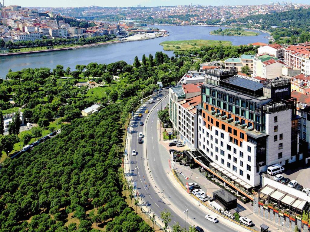 an aerial view of a building and a road next to a river at Mövenpick Istanbul Hotel Golden Horn in Istanbul