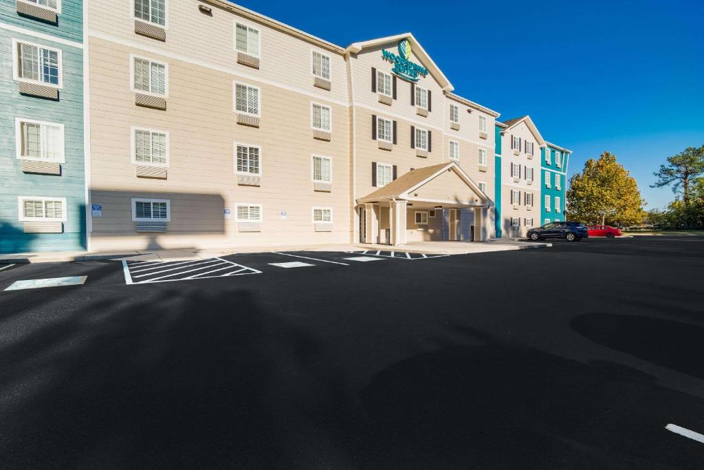 an empty parking lot in front of a building at WoodSpring Suites | North Charleston Airport I-526 in Charleston