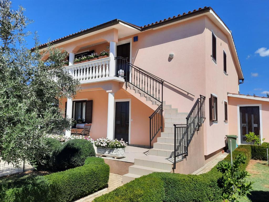 a large house with stairs and a balcony at Apartment Katarina in Vodnjan