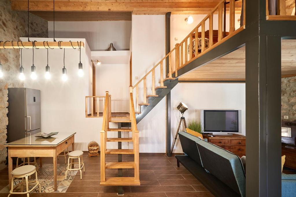 a loft conversion with a staircase and a desk and a television at Casa Fonte da Mina in Fundão