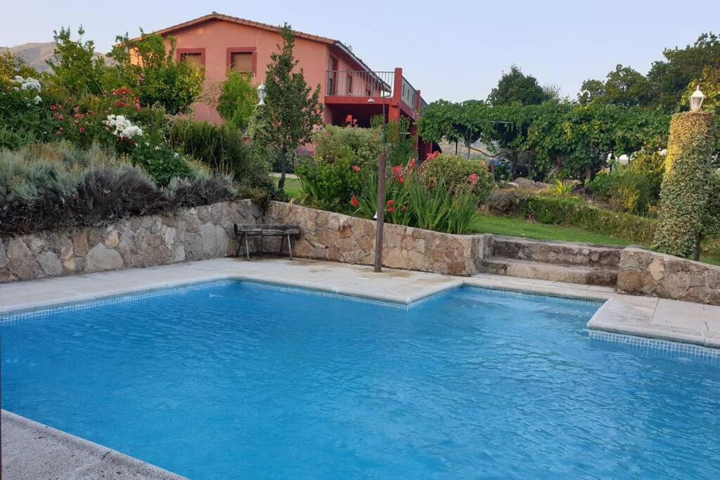 a swimming pool in front of a house at CASA RURAL LAS TRAVIESAS 2 in Candeleda