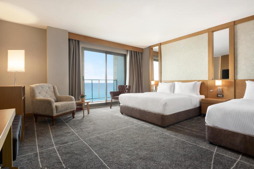 A bed or beds in a room at Ramada Resort by Wyndham Unye