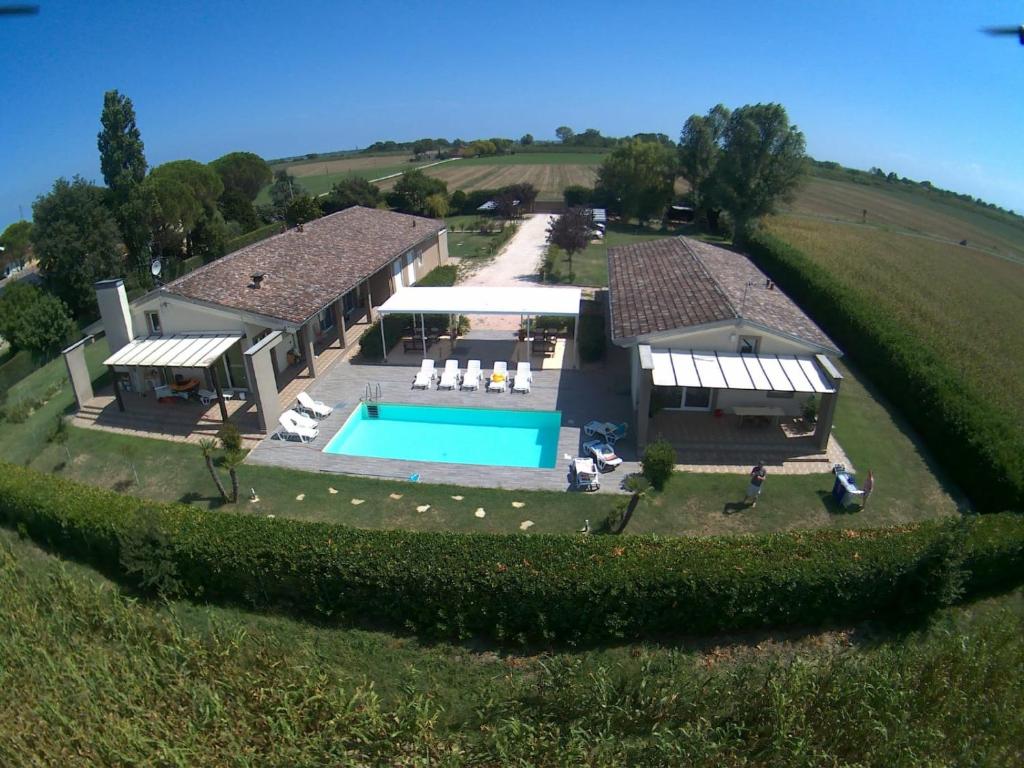 an aerial view of a house with a swimming pool at Ca Giuliocesare in Castiglione di Ravenna
