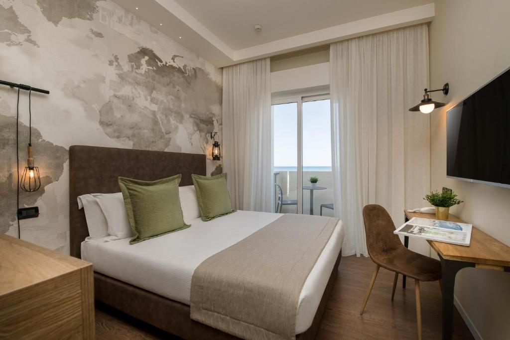Postel nebo postele na pokoji v ubytování Litoraneo Suite Hotel
