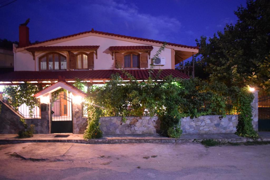 a house with lights in front of it at night at Family Villa Kalypso in Oreoí