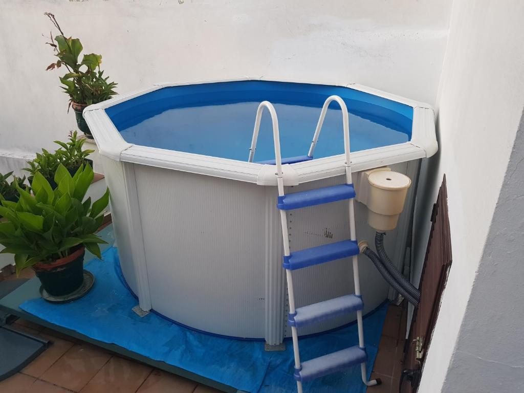 a swimming pool with a ladder next to a bucket at Casa Ignacio in Arriate