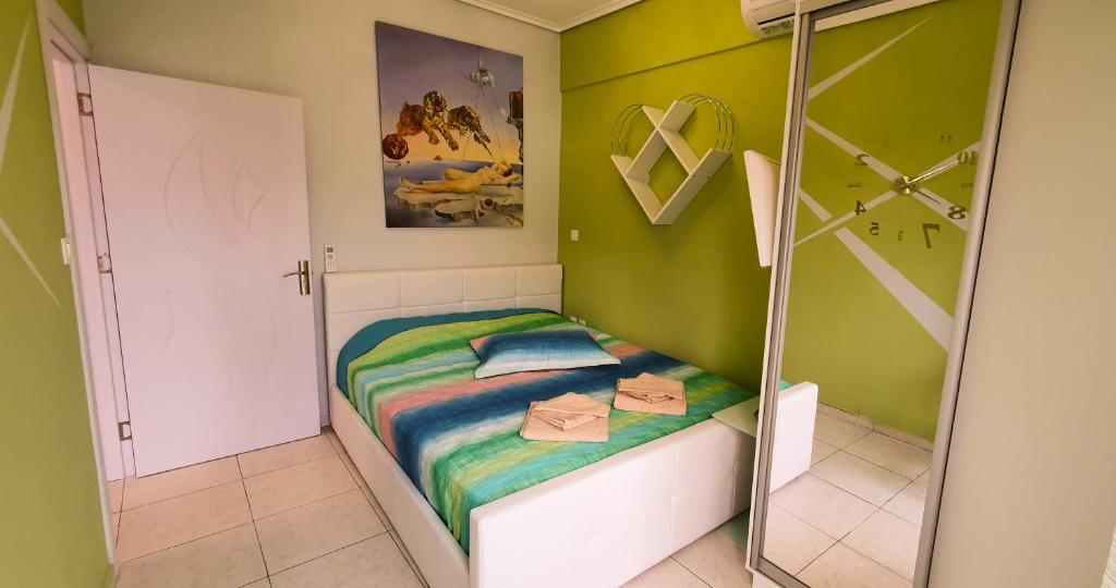 a small bedroom with a bed and a mirror at Apollo 2 - Luxury Apartment in Katerini