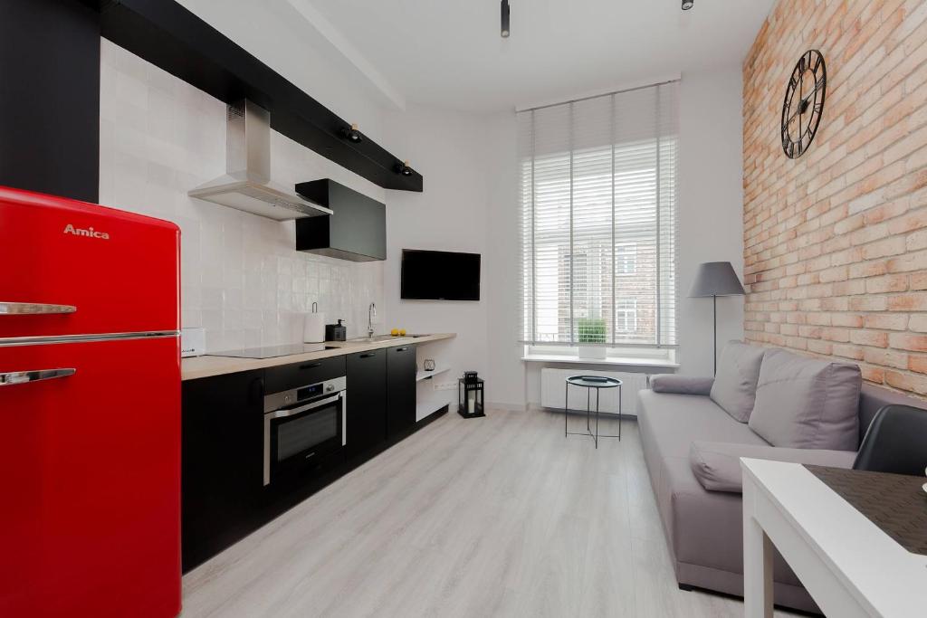 a kitchen and a living room with a red refrigerator at 4 ECO Apart Chateau Jagiellonska 22 Warszawa Old Town in Warsaw