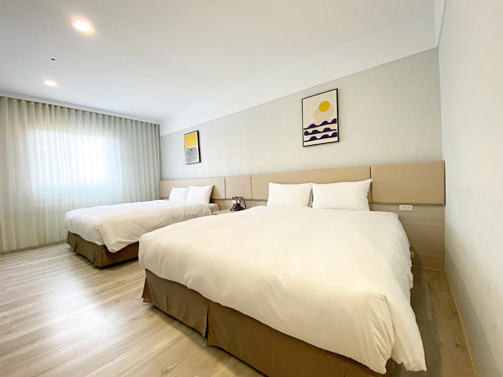 Postel nebo postele na pokoji v ubytování Fengjia JinRui Hotel