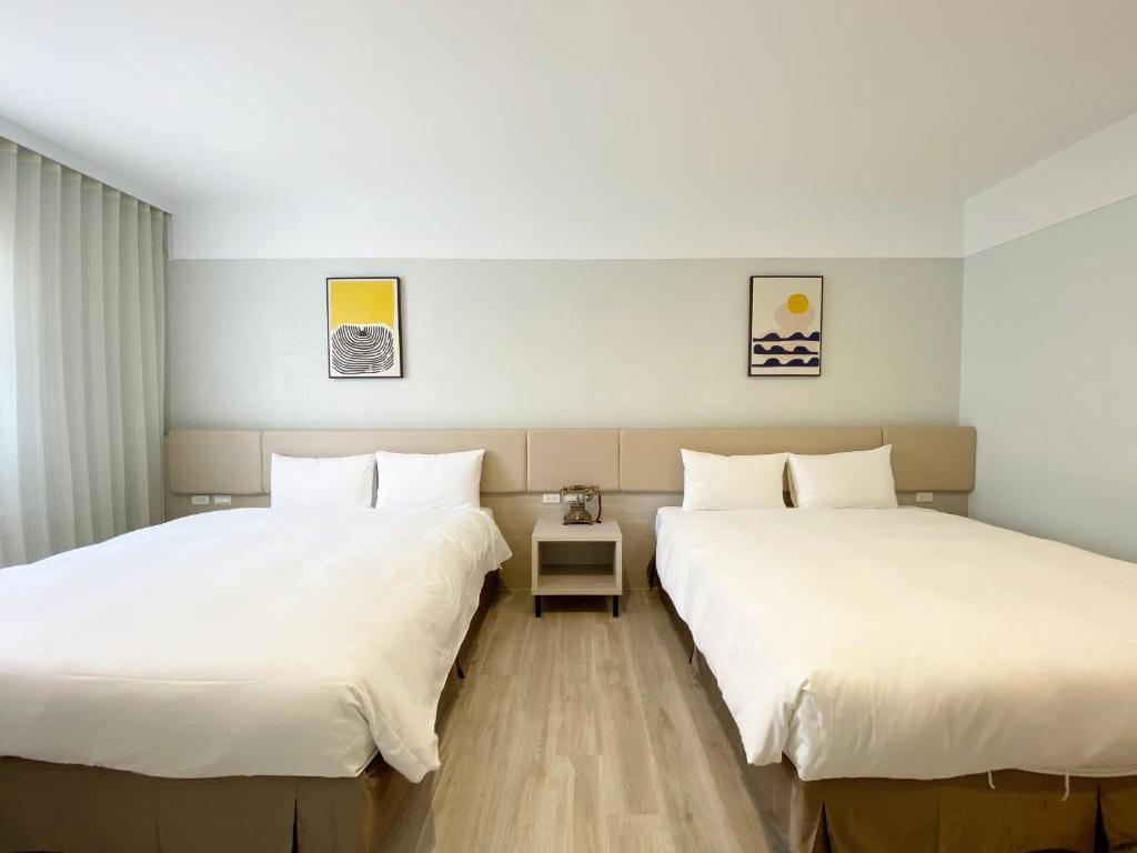 Postel nebo postele na pokoji v ubytování Fengjia JinRui Hotel