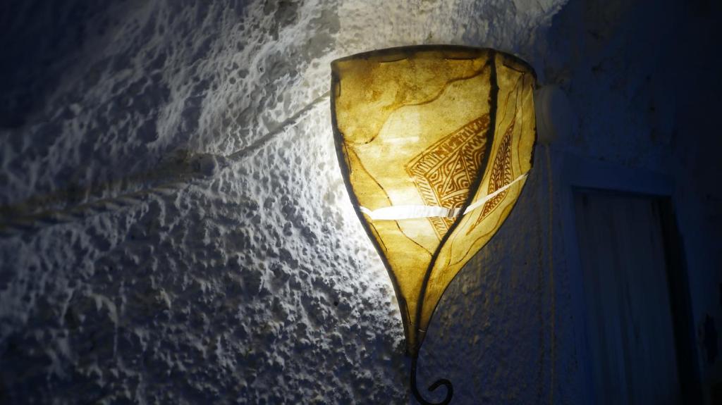 a lamp hanging from a wall in a room at Casa Cueva “La Estrella” in Granada