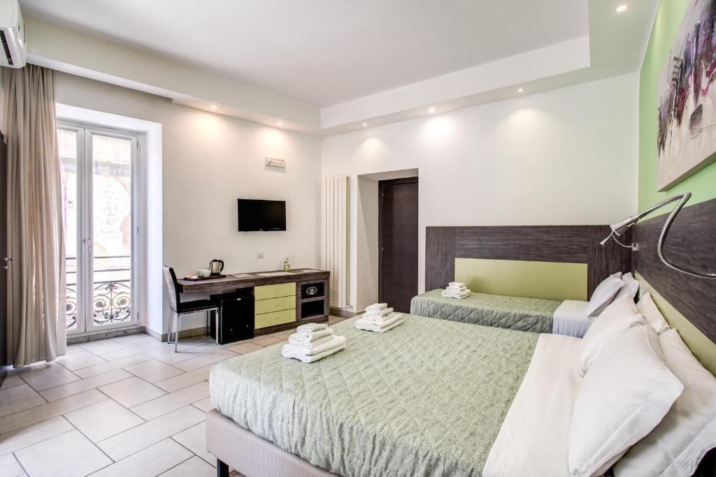 Posteľ alebo postele v izbe v ubytovaní Napoli Suite