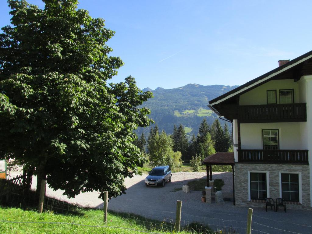 a car parked in a parking lot next to a building at Reitercamp Ortnerhof in Ramsau am Dachstein