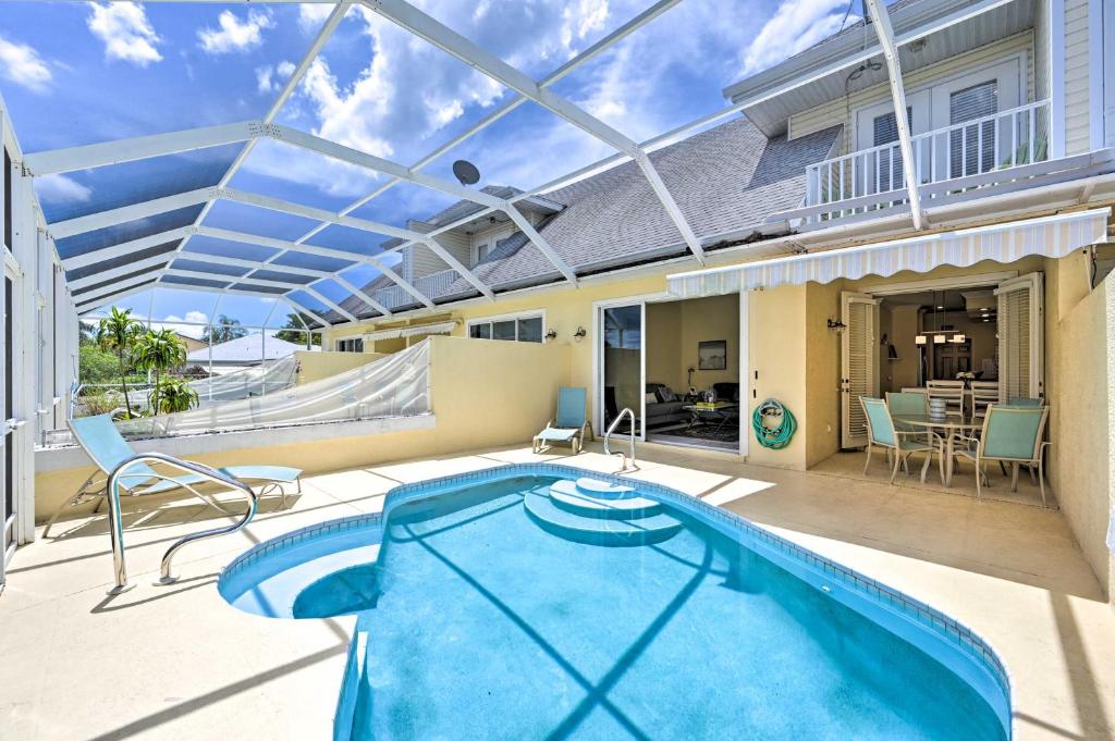 a patio with a swimming pool and an outdoor deck with a swimming pool at Cape Coral Escape with Screened Pool, Near Beaches! in Cape Coral