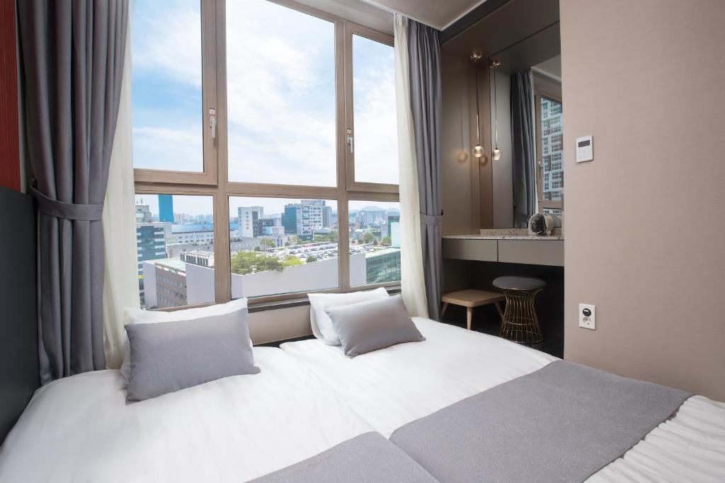 Postel nebo postele na pokoji v ubytování Utop Boutique Hotel&Residence