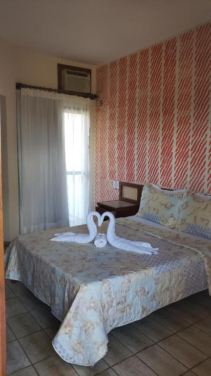 Postel nebo postele na pokoji v ubytování Pousada Enseada do Corsário