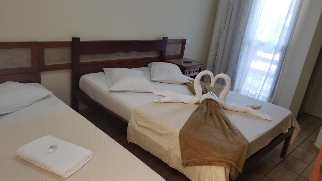 Postel nebo postele na pokoji v ubytování Pousada Enseada do Corsário