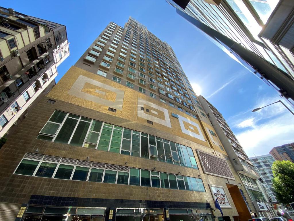 a tall building with a sign on the side of it at Ramada Hong Kong Grand in Hong Kong