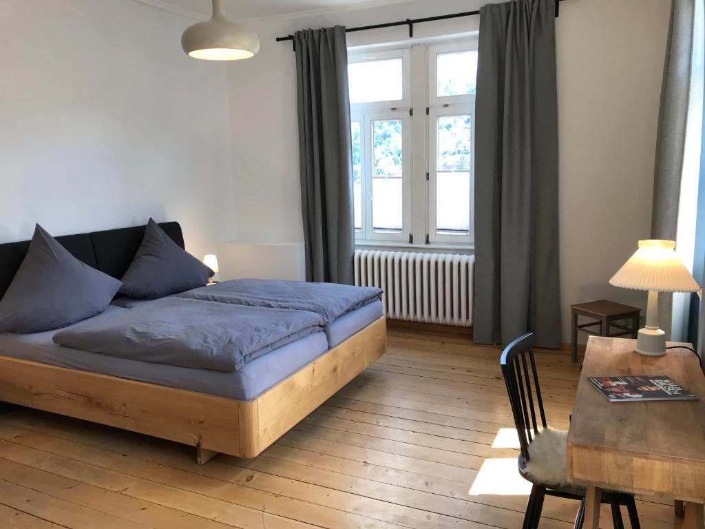 ein Wohnzimmer mit einem Bett, einem Tisch und einem Fenster in der Unterkunft Stilvolle Ferienwohnung im Herzen von Triberg in Triberg
