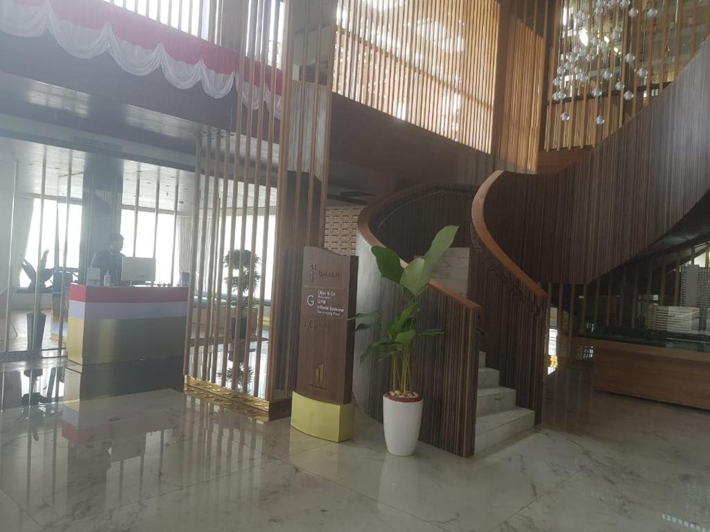 a lobby with a potted plant in a building at One Residence #11AI in Batam Center