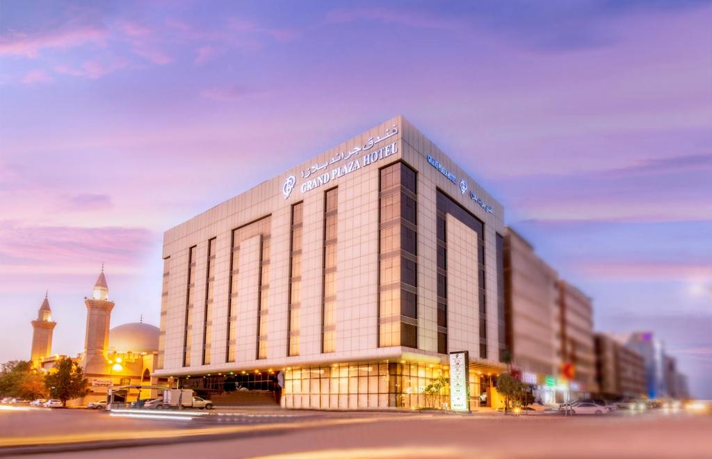 a large building in a city with a clock tower at Grand Plaza Hotel - Dhabab Riyadh in Riyadh