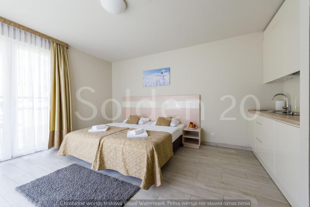 sypialnia z łóżkiem i dużym oknem w obiekcie Apartament Czarna Góra Sienna SOL w mieście Sienna