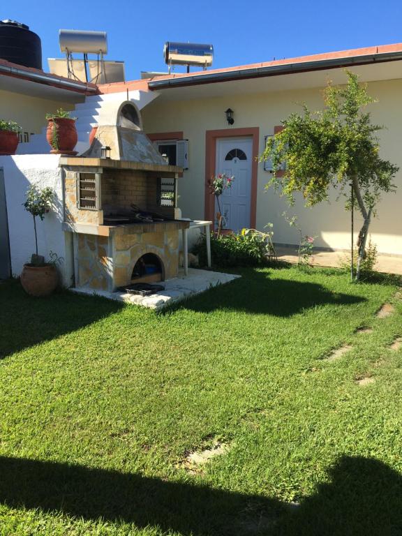 a stone oven in the yard of a house at Anna Studios in Agios Georgios