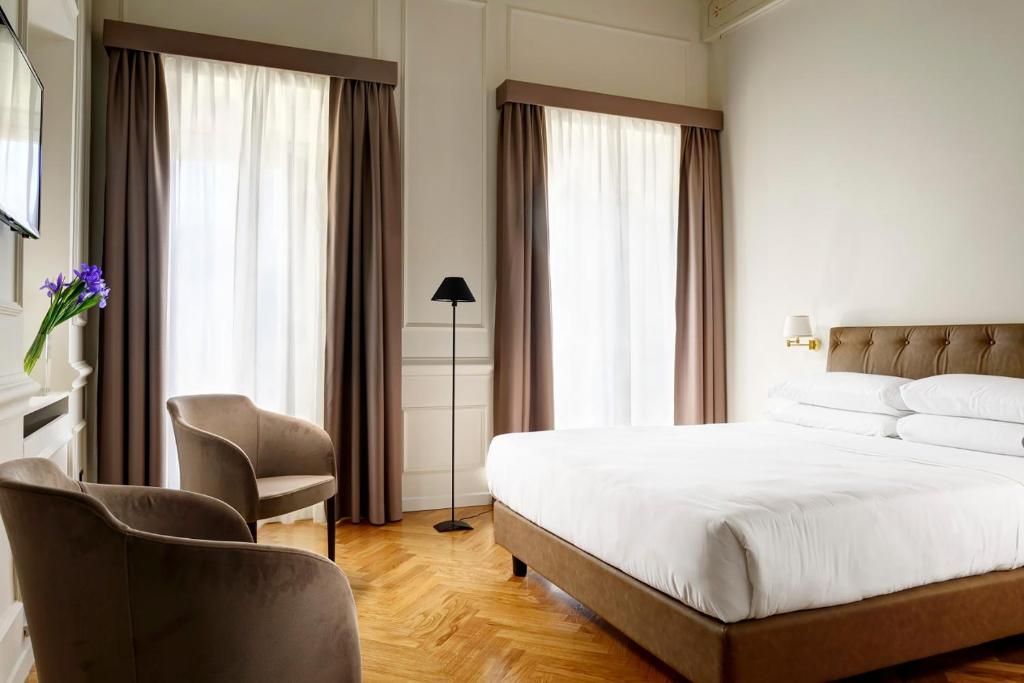 A bed or beds in a room at Splendor Suite Rome - Suites & Apartments