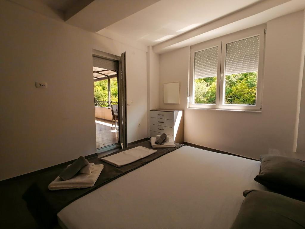 a bedroom with a large bed and a window at Apartments st.Martinia in Ohrid
