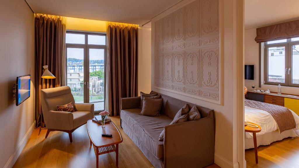 a living room with a couch and a bed at Marpessa Hotel & Spa in Agrinion