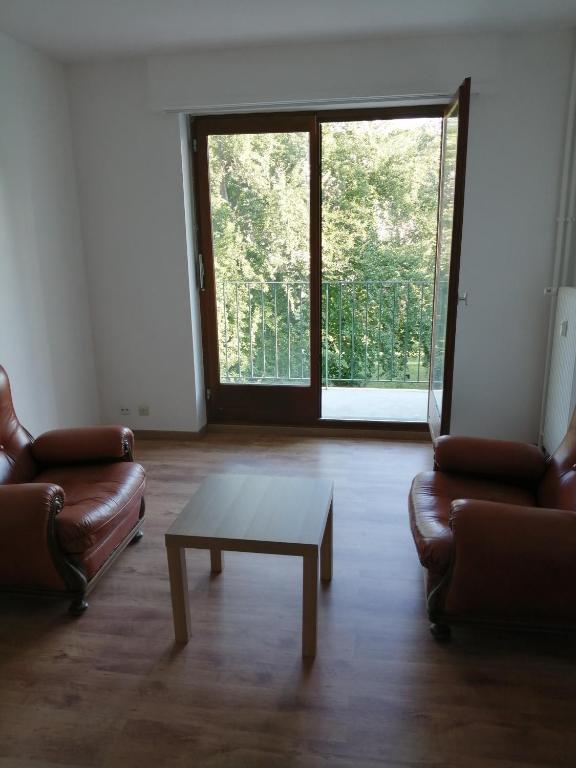 a living room with two couches and a coffee table at Appartement cosy arrêt de tram Saint-Louis Grenze in Saint-Louis