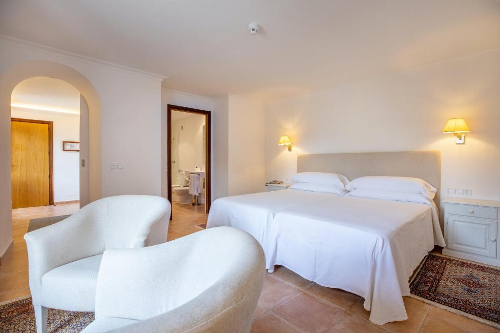 Un ou plusieurs lits dans un hébergement de l'établissement Hotel Llenaire