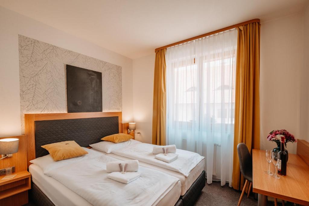 Postel nebo postele na pokoji v ubytování Hotel Klika
