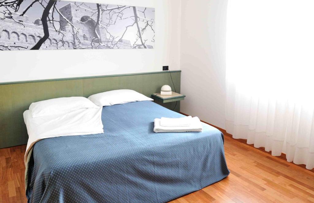 Postel nebo postele na pokoji v ubytování Rometta Hotel