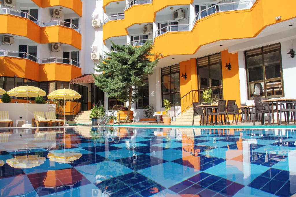 a swimming pool in front of a building at Yaman Life Hotel in Alanya