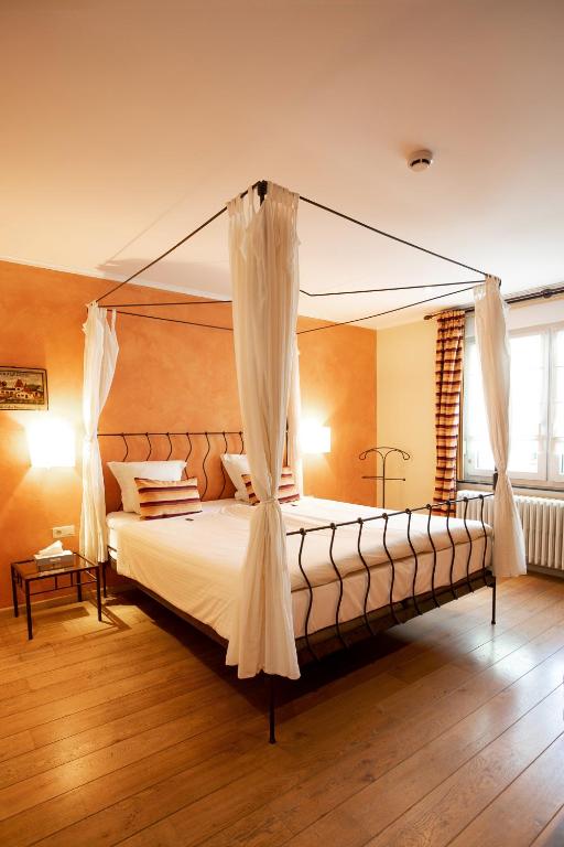 a bedroom with a large bed with a canopy at Gourmet Hotel Zur Post in Saint-Vith