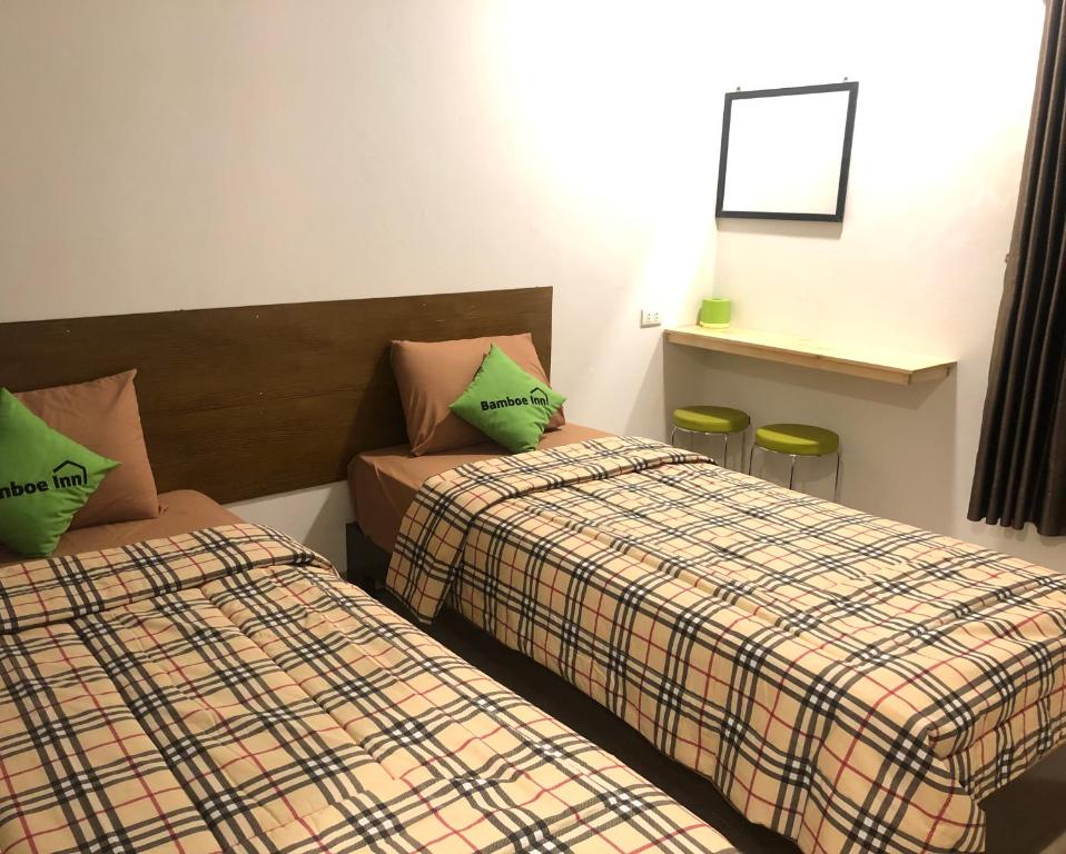 Postel nebo postele na pokoji v ubytování Bamboe Inn Homestay