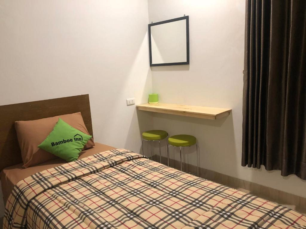 Postel nebo postele na pokoji v ubytování Bamboe Inn Homestay
