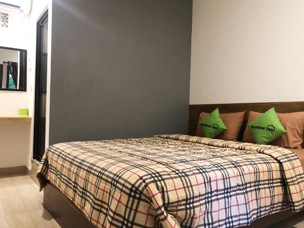 Postel nebo postele na pokoji v ubytování Bamboe Inn Homestay