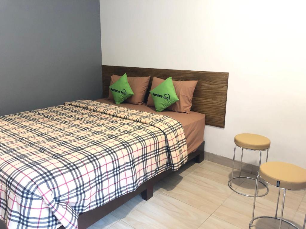 Postel nebo postele na pokoji v ubytování Bamboe Inn Homestay