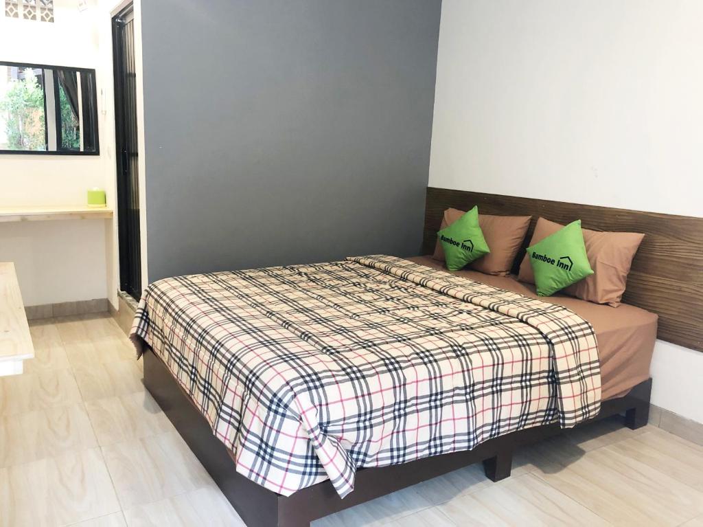 Postel nebo postele na pokoji v ubytování Bamboe Inn Homestay